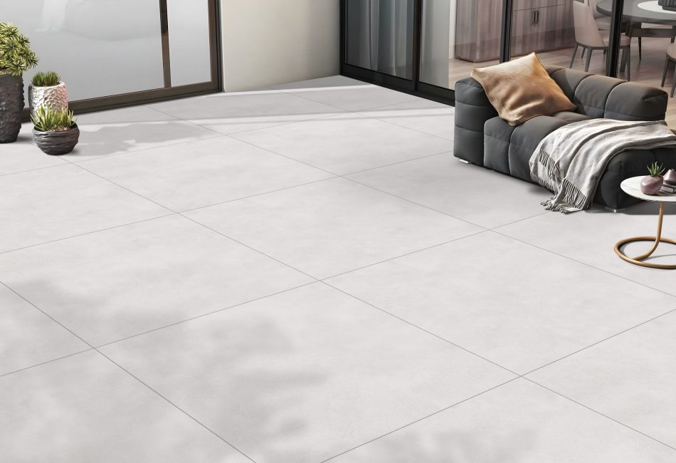 a patio with a light color with 48x48 concrete look tile in light earth tones