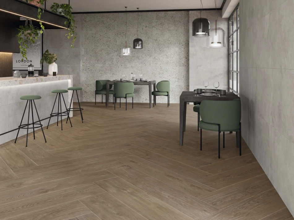 A modern kitchen with a white island and walnut color wood looking porcelain floor